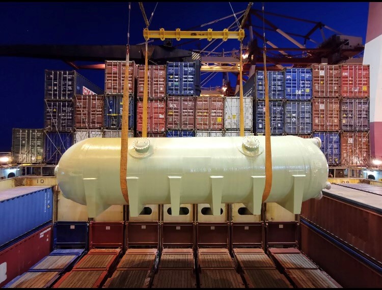 Oversized industrial cargo being lifted aboard a vessel